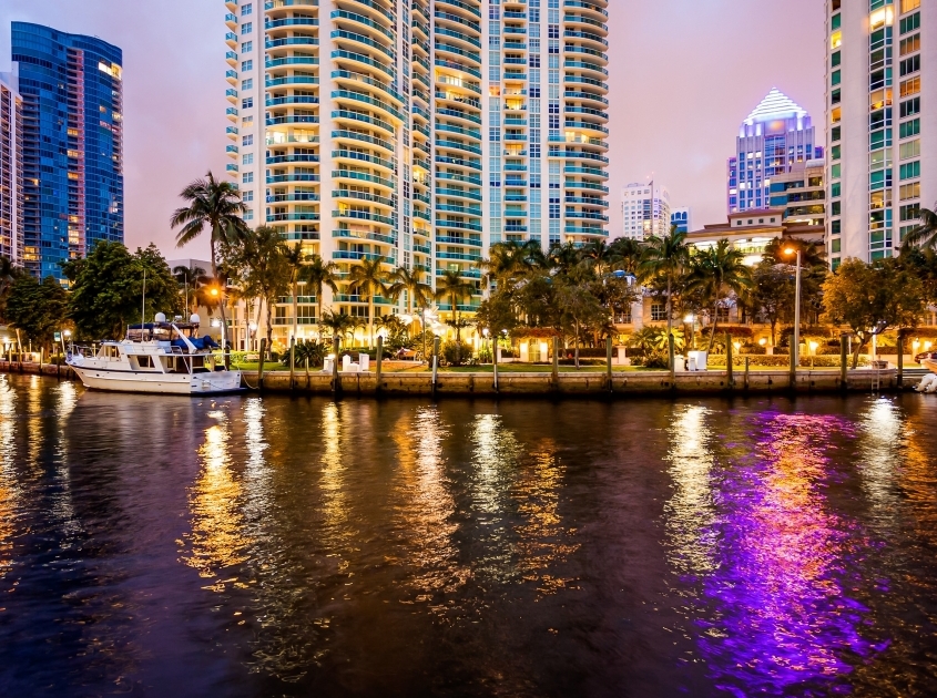 Downtown Fort Lauderdale high-rises and marina at night showing the areas served by Campos Investigations in Broward, Miami-Dade, and Palm Beach